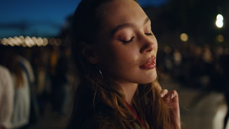 portrait trendy woman partying at night town looking camera. girl in city life