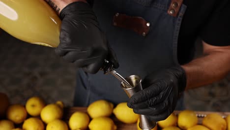 Bartender Pouring Lemon Juice into Jigger