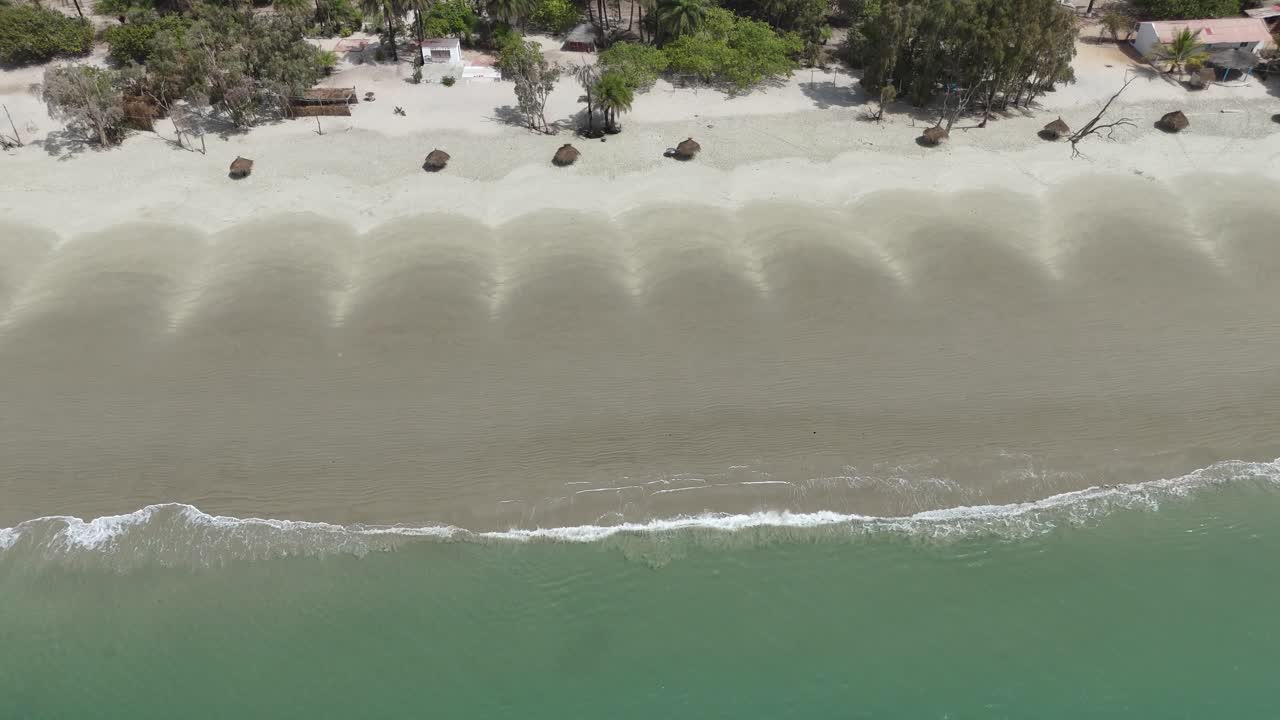 Golden light over mangroves and ocean waters in the Bijagós Islands, creating a serene tropical landscape from above