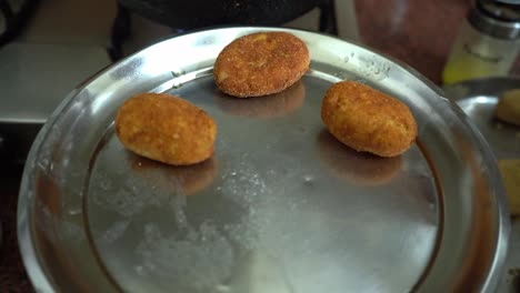 freshly cook potato cutlet placing in silver plate