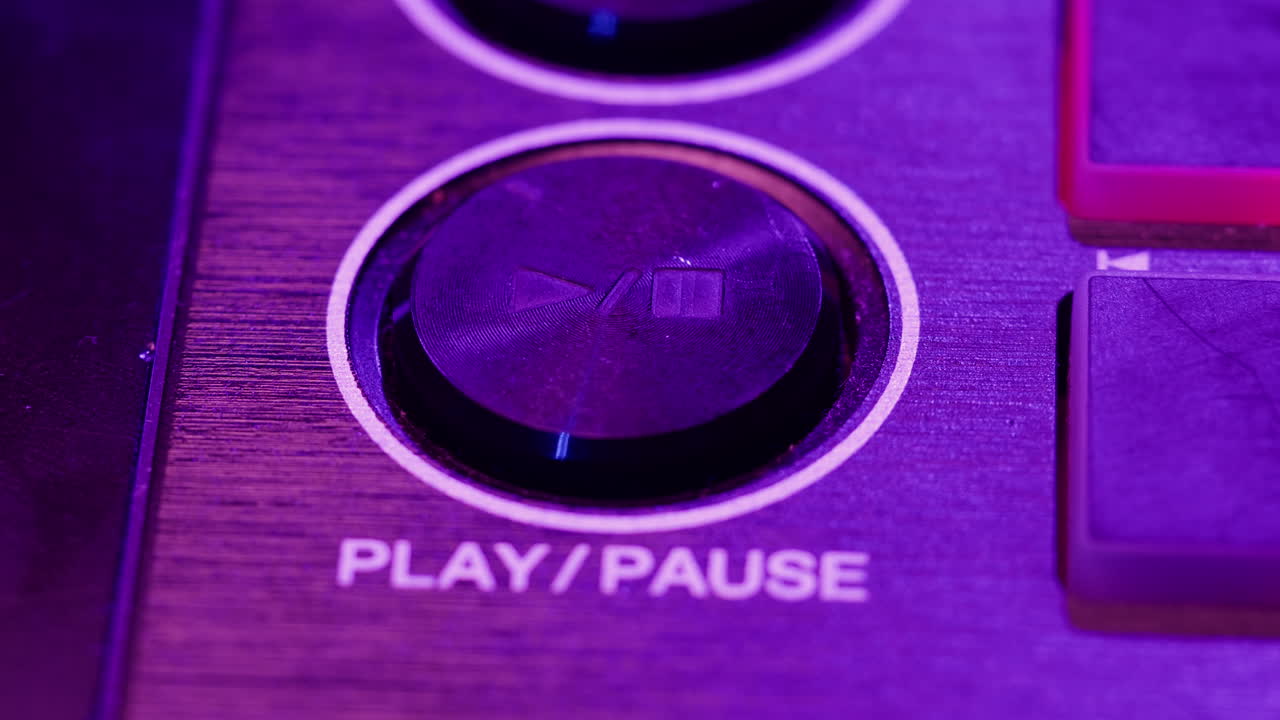 DJ with headphones and sunglasses playing music on festival in night club. Techno musician performing at nightclub for concert crowd of people, city bar.
