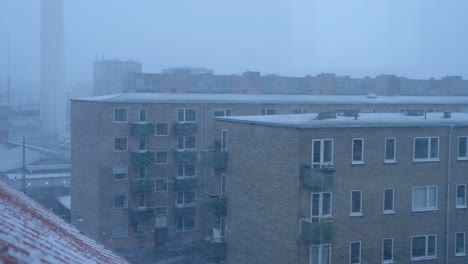 a blizzard on a winter's day in copenhagen seen from the top floor