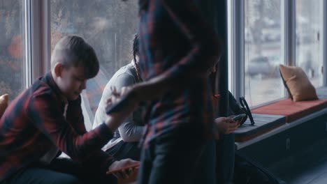teenagers using phones in a common area