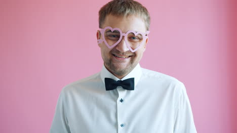 man wearing heart-shaped glasses and bowtie