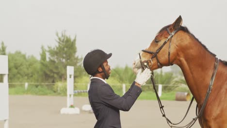 african american man looking at his dressage horse