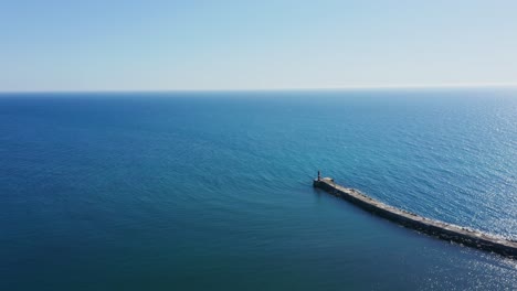 idyllic view of vila do conde coast and small breakwater, portugal - aerial