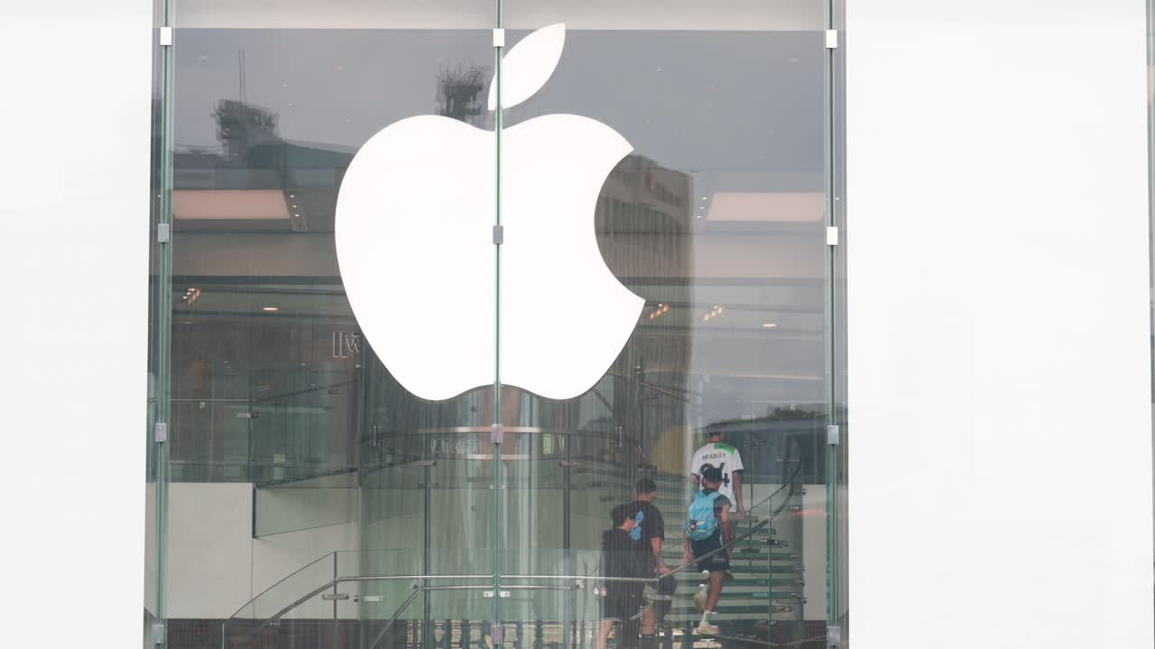 Customers ascending the staircase at the Apple Store, the American tech company.