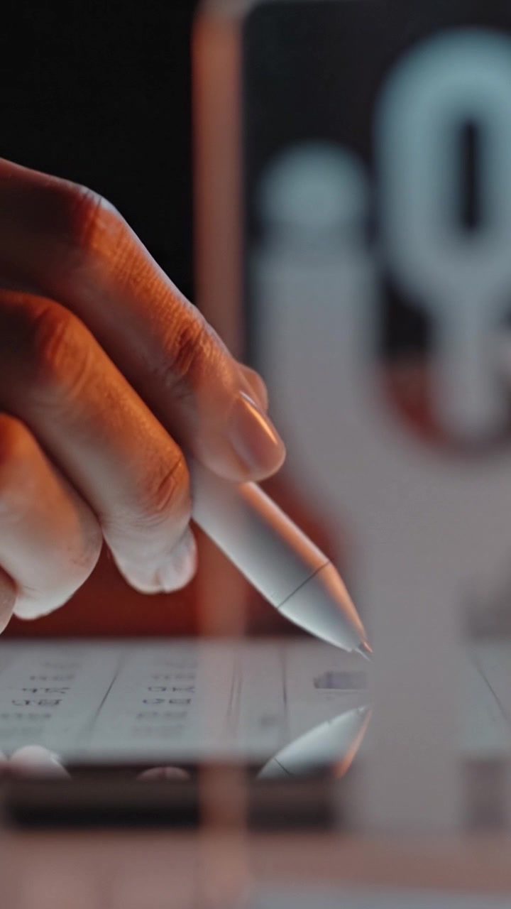 Exploring Digital Creativity: Close-up of a Hand Using a Stylus on a Touchscreen with Innovative Background Elements in a Modern Workspace Setting