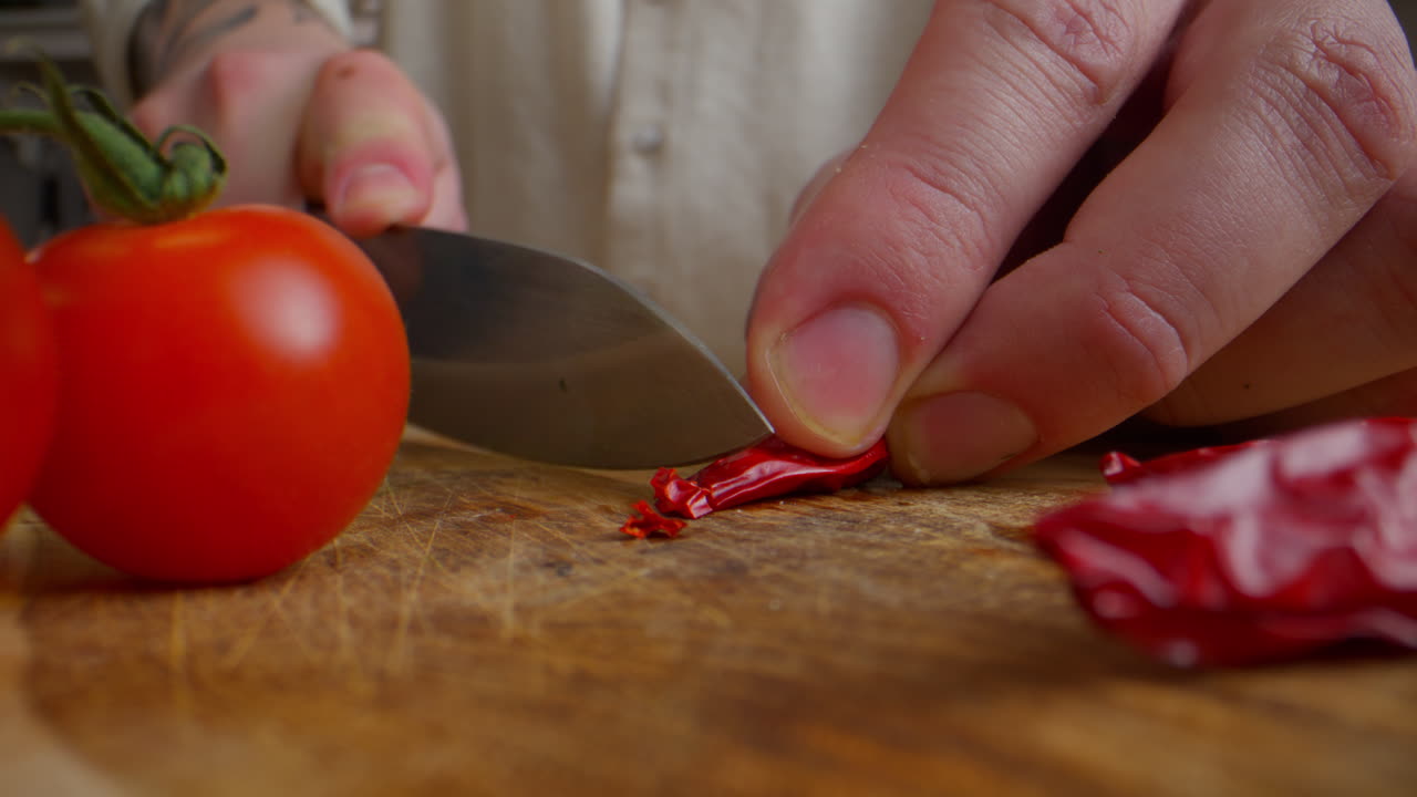 Chef Chopping Red Chili Peppers