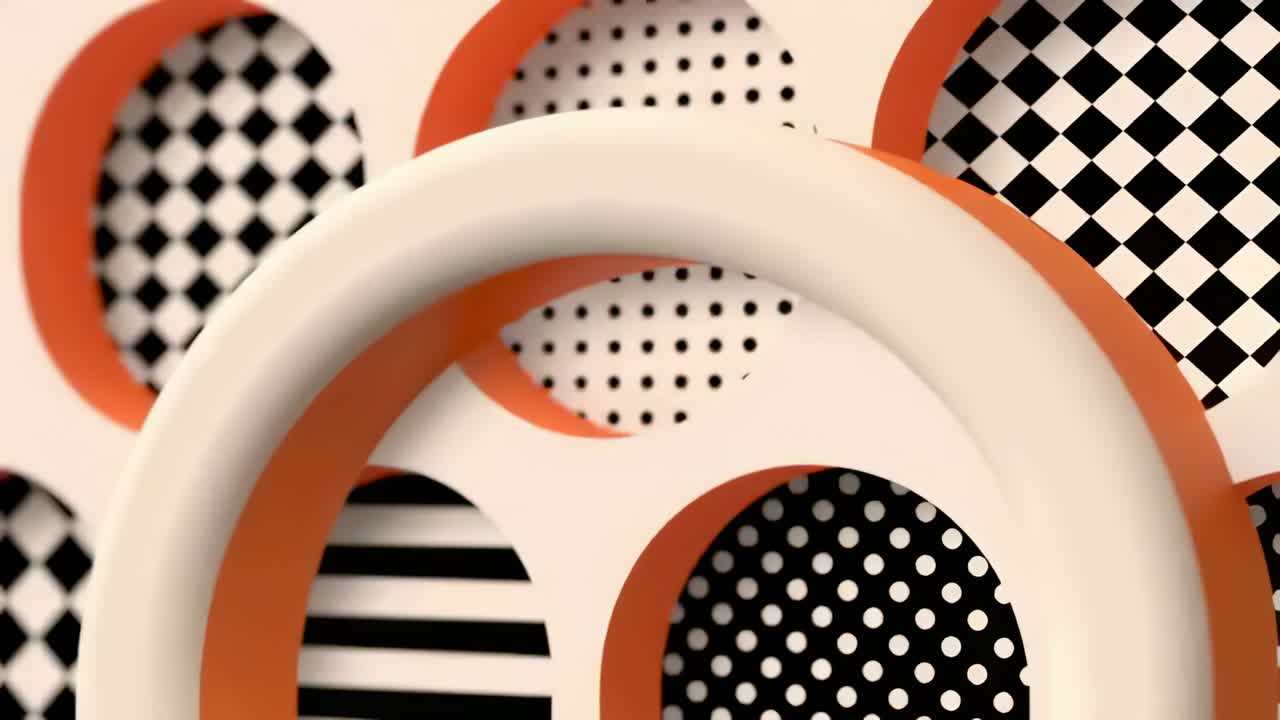 L'animation commence, un tore blanc lisse en rotation glisse en studio, révélant des motifs à bordure orange.