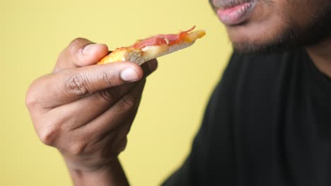 persona comiendo una rebanada de pizza