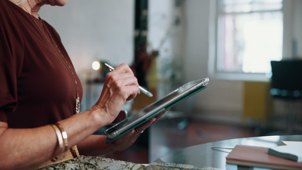 Senior Woman Using Digital Tablet with Stylus