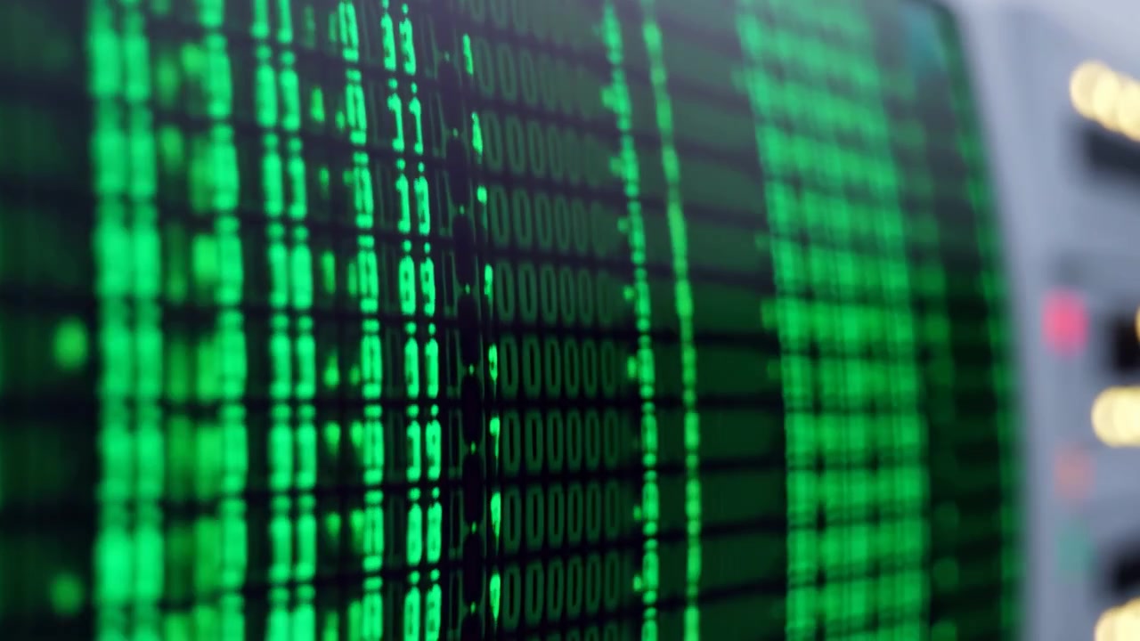 Curved electronic display showing vertical green illuminated digits and pixel rows with layered focus, soft bokeh lights, subtle reflections, and crisp central detail against blurred surrounding areas