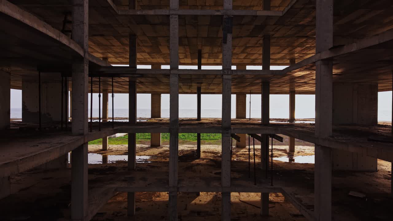 Aerial view of an unfinished concrete structure near the coast