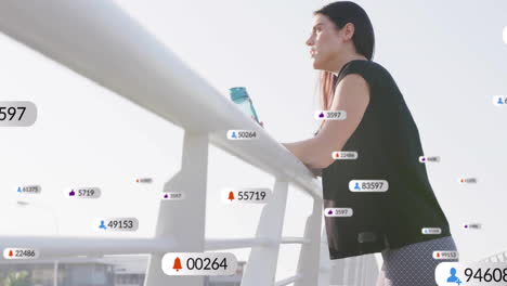 leaning on railing, woman holding bottle with social media notifications animation over