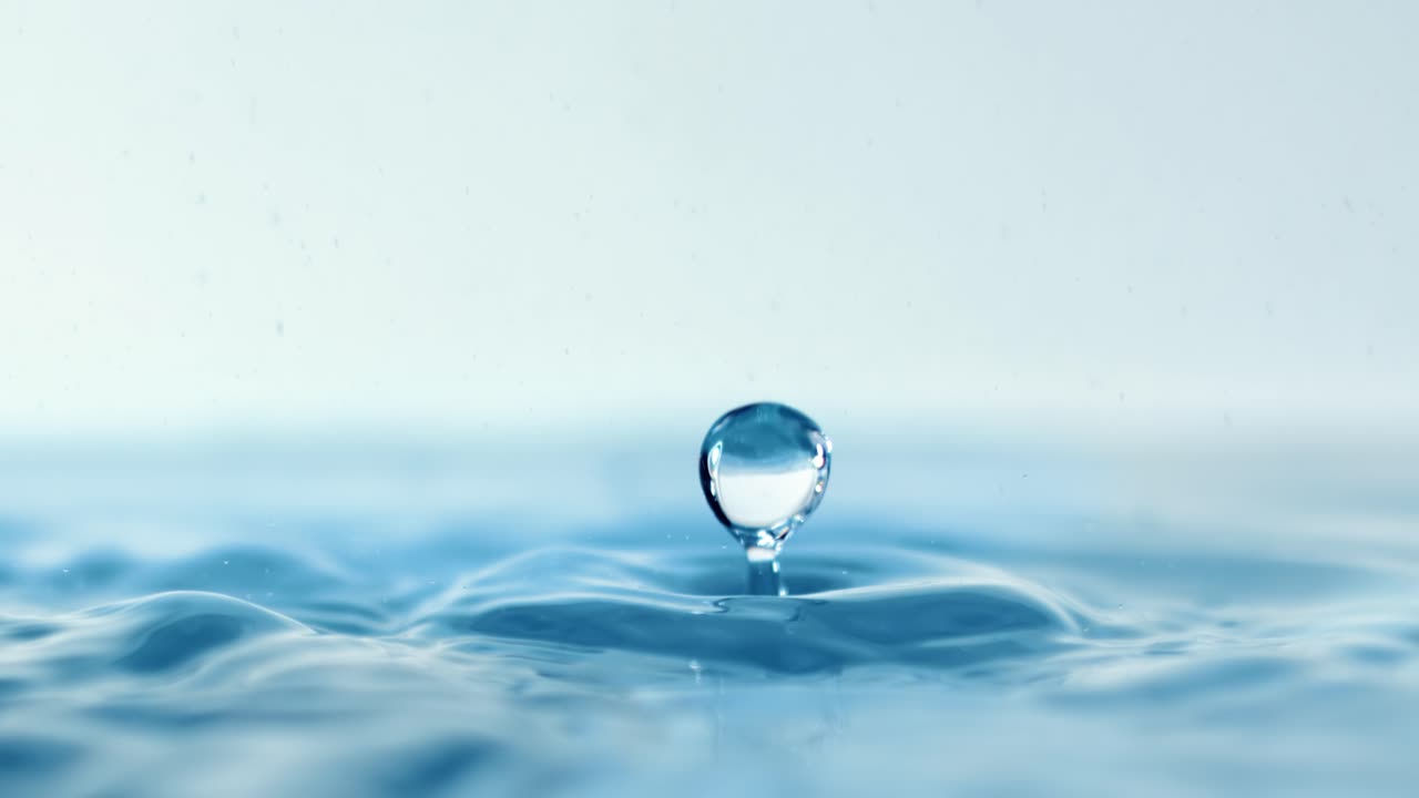 Drop close-up of water falls in a super slow motion.