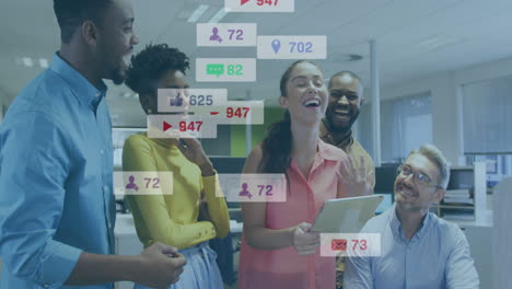 animation of social media icons against team of diverse colleagues discussing laughing at office