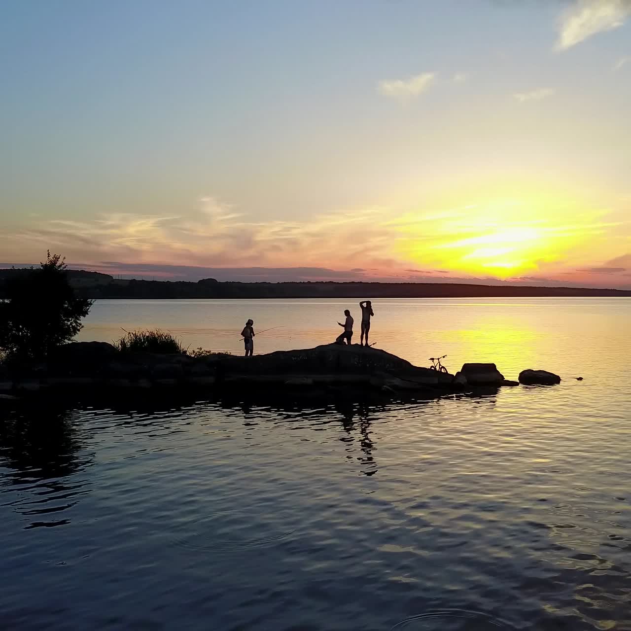 People Enjoying the Riverside Sunset