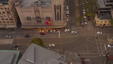 static aerial view of peak hour traffic moving through melbourne intersection