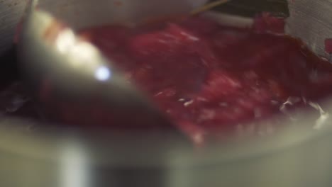 Mixing borsch in pan