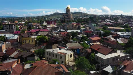 Aerial:-Tbilisi-city-centre-with-Metekhi-Church-in-background,-Georgia-capital