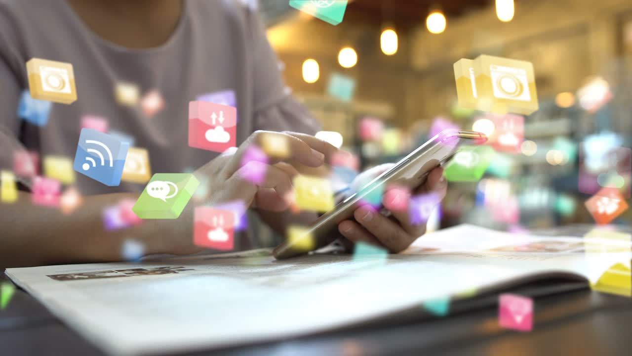 Hand using smartphone with social media icons