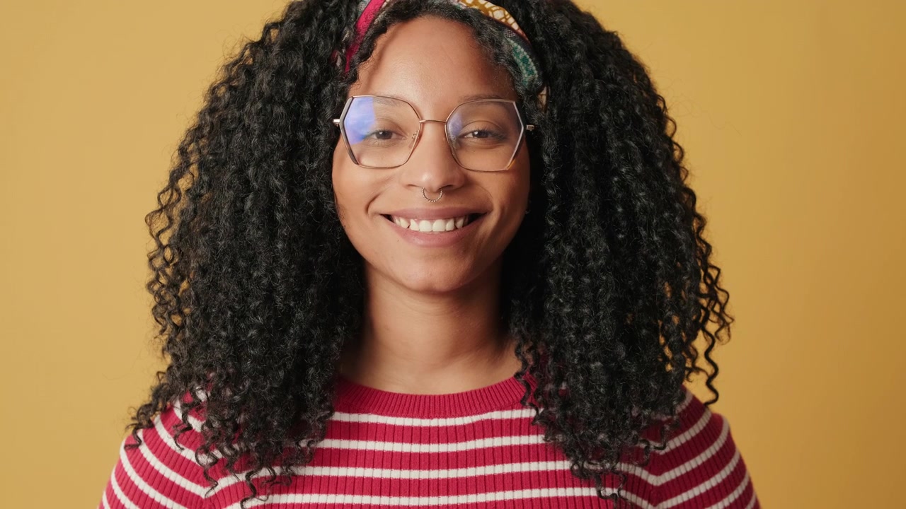 Young Woman With Curly Hair Opening Eyes and Smiling