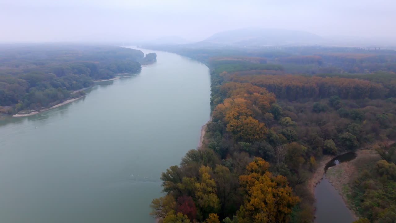 Scenic View Of Foggy Autumn Forests Along The Danube River. Aerial Drone Shot