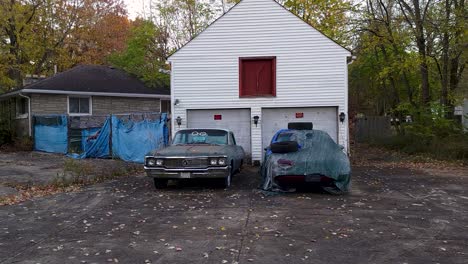 Slider-Shot-Of-Old-House-With-Two-Collection-Cars-In-Far-Village