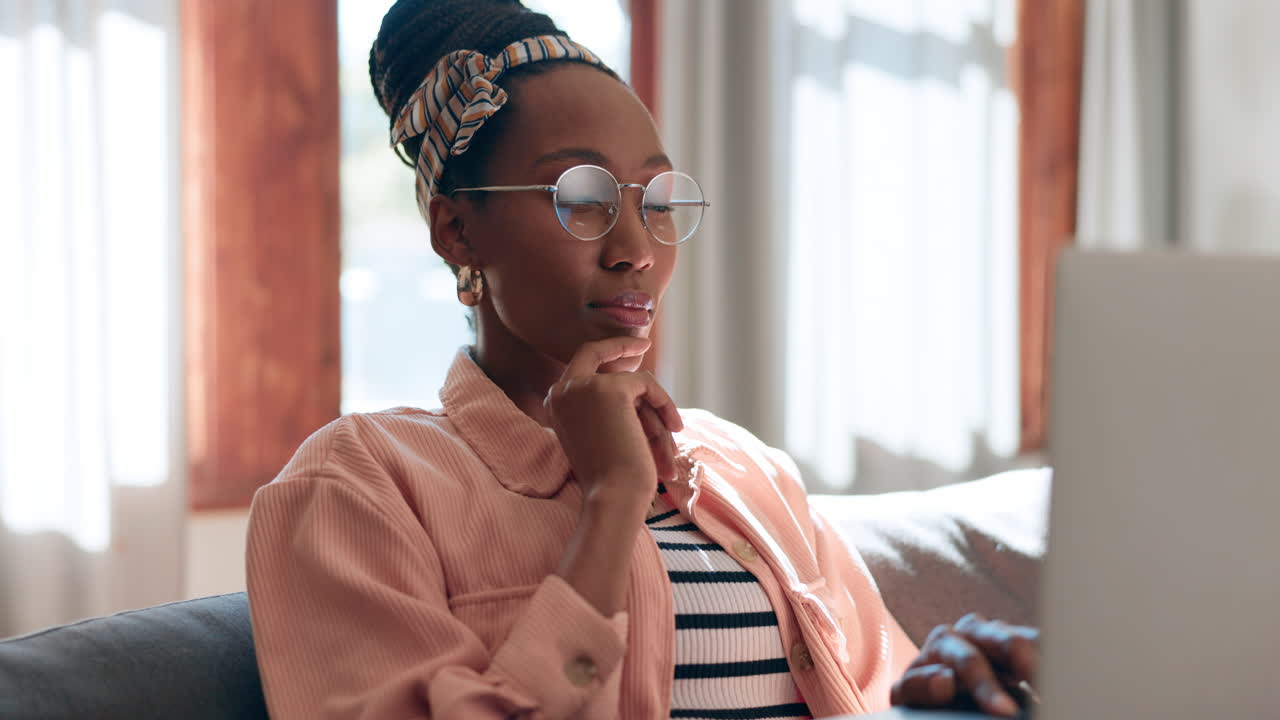 Home, thinking and black woman with a laptop