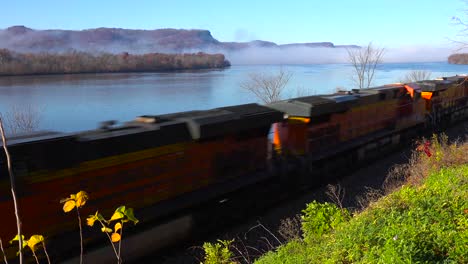 a freight train rolls along the mississippi river