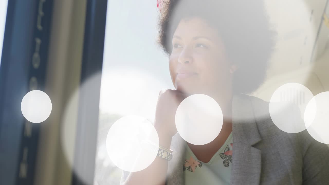 Woman gazing bus window during travel as shifting lens flares gradually revealing reflective smile