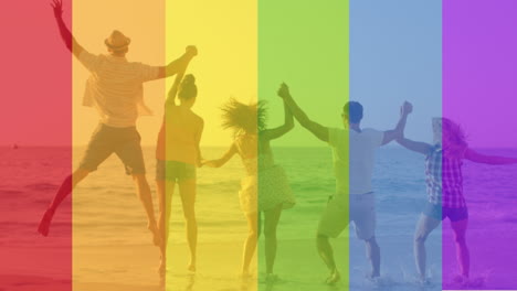 animation of rainbow over group of happy people on the beach