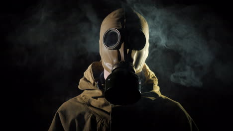 a man in a protective suit and gas mask smoke in the foreground