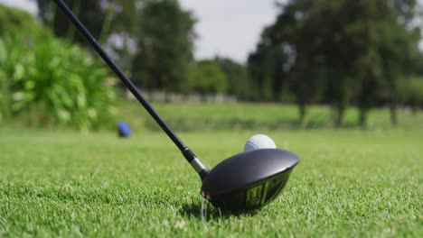 Caucasian-woman-playing-golf-taking-a-shot-from-bunker