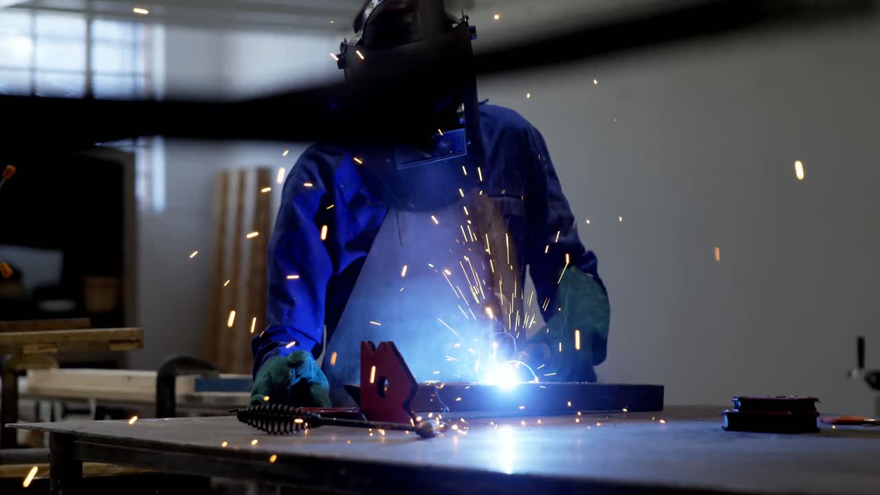 Female welder using blow torch on a rod 4k
