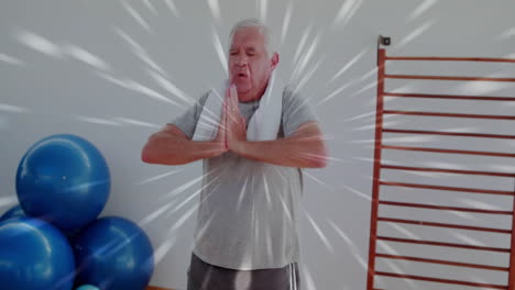 radiating light burst animation over man exercising with gym equipment