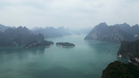scenic landscape of limestone karsts and misty green lake