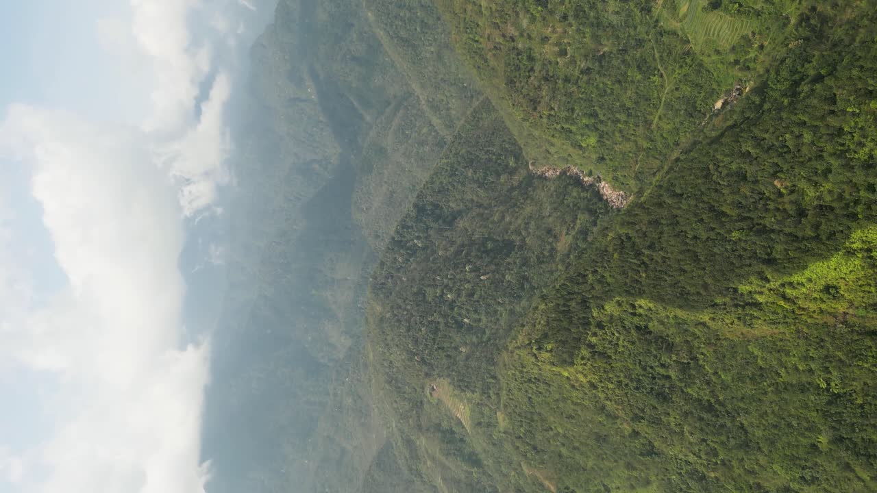 Vertical - Fog Clouds Over Lush Green Mountains In Sapa, Vietnam. drone shot