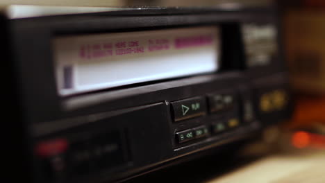 Pressing-Stop-and-Eject-Button-on-VHS-Player-and-Taking-Out-Video-Cassette-Tape,-Close-Up