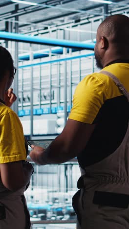 vertical video industry 4.0 industrial plant engineering team controlling automated machinery
