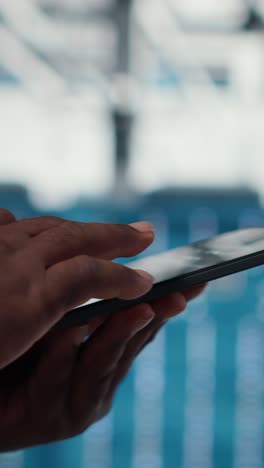 vertical video close up of admin in data center workplace using tablet