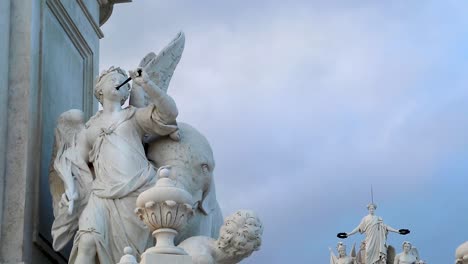 statue of angel at praça do comércio, terreiro do paço, right by the tagus river, in the center of lisbon, portugal.