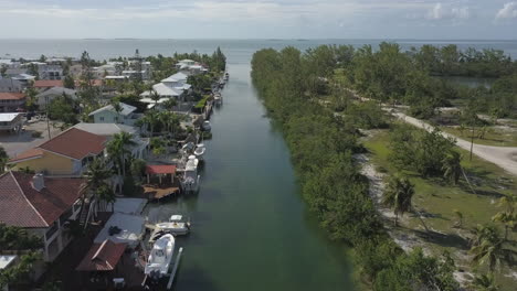 Slow-flying-over-canal-in-neighborhood-in-Islamorada,-Florida