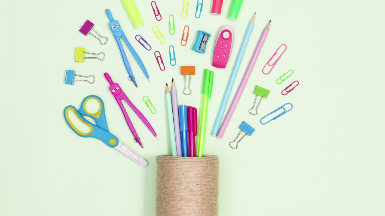 School and writing stationery move in pencil holder on green theme. Stop motion