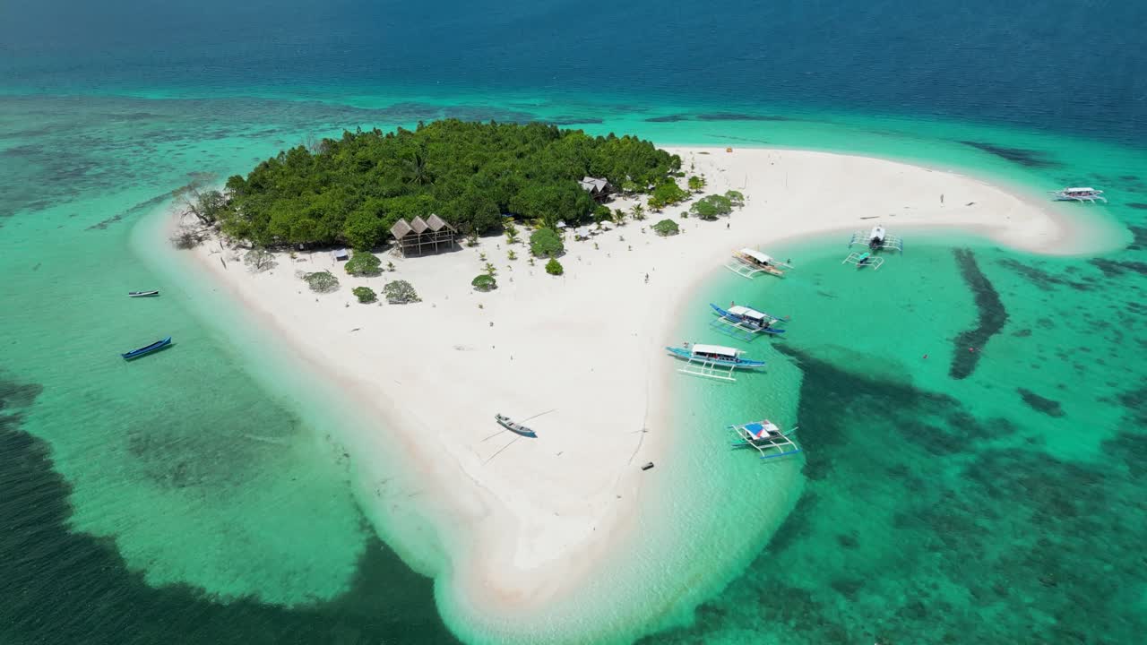Premium stock video - Rising tilt down reveals calm tropical shoreline ...