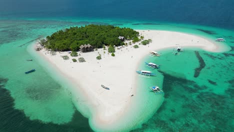 rising tilt down reveals calm tropical shoreline of patawan island balabac