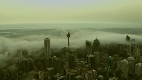 foggy misty morning over sydney city skyline with fog streaming between the buildings