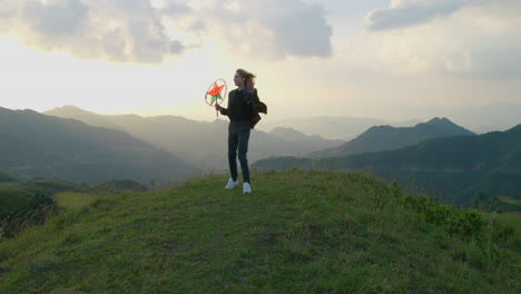 slow motion shot of a woman posing on a mountain holding a star lantern