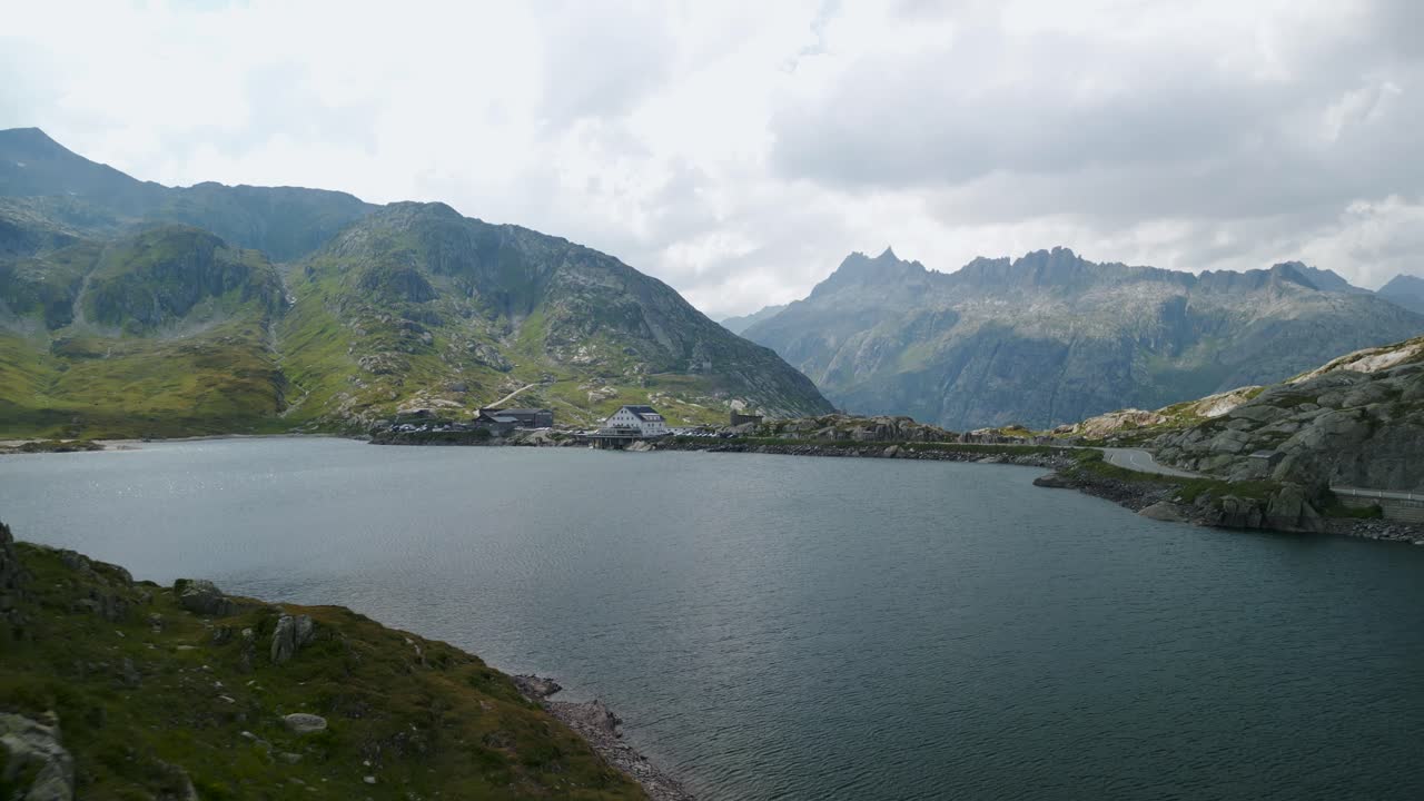 Aerial approach of Hotel Grimsel Passh&ouml;he or Grimselpass in Switzerland from Totensee or Titinsee Lake in summer season